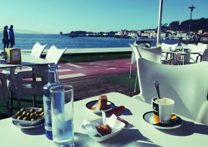a table with a plate of food and a drink at Villa Lukita in Cangas de Morrazo
