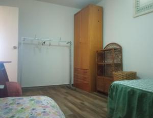 a room with a closet and a dresser and a bedroom at Villa Lukita in Cangas de Morrazo