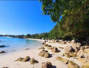 a beach with rocks in the sand at Villa Lukita in Cangas de Morrazo