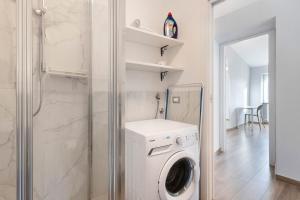 a white washer and dryer in a bathroom at Residenza del Capitano in Levanto