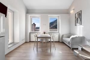 a living room with a table and chairs and a couch at Residenza del Capitano in Levanto