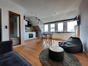 a living room with a couch and a table at Ferienwohnung Möwennest by Deju in Norderney