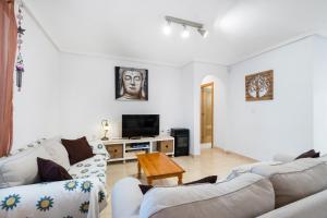 a living room with two couches and a tv at Casa Max in Gran Alacant
