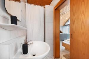 a white bathroom with a sink and a mirror at Gästehaus Noller in Bodman-Ludwigshafen +53 photos