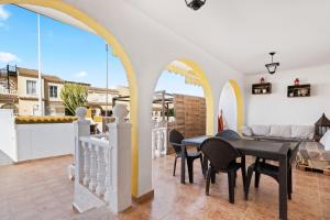 a dining room with a table and chairs on a balcony at Casa Max in Gran Alacant