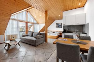 a living room with a couch and a table at Gästehaus Noller in Bodman-Ludwigshafen