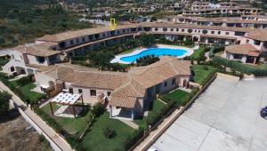 an aerial view of a mansion with a swimming pool at Casa Vacanze Cocco in Porto San Paolo +9 photos