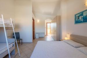 a bedroom with two bunk beds and a hallway at Casa Vacanze Cocco in Porto San Paolo