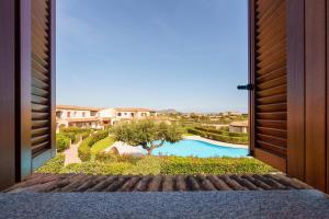 a view of a swimming pool from a door at Casa Vacanze Cocco in Porto San Paolo