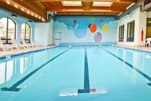 a large swimming pool with chairs and a wall with balloons at Penn Wells Lodge in Wellsboro