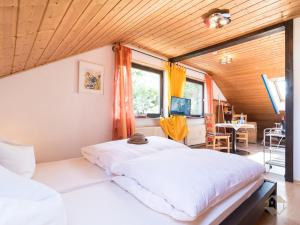 a bedroom with a large bed in a room at Haus Umbeer in Schömberg
