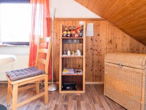 a room with a chair and a book shelf at Haus Umbeer in Schömberg