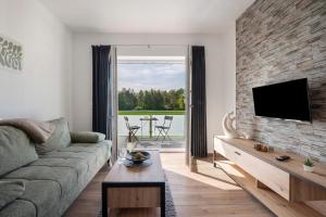 a living room with a couch and a tv at Gästehaus Anna in Suhle