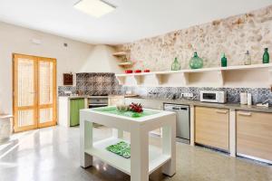 a kitchen with a white table in a room at Cases d’Alcudiarrom in Vilafranca de Bonany