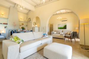 a living room with a white couch and a table at Villa Armonia in Pyrgi