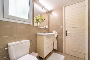 a small bathroom with a toilet and a sink at Villa Armonia in Pyrgi +24 photos