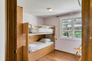 a small room with bunk beds and a window at Olga in Platja d'Aro
