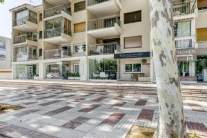 an empty street in front of an apartment building at Olga in Platja d'Aro