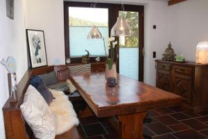 a living room with a wooden table and a couch at Haus Talblick Sasbachwalden in Sasbachwalden +34 photos