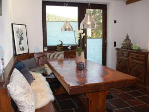 a living room with a wooden table and a couch at Haus Talblick Sasbachwalden in Sasbachwalden