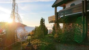 a bench next to a house with the sun setting at Haus Talblick Sasbachwalden in Sasbachwalden