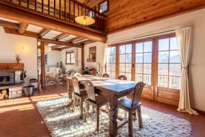 a dining room with a wooden table and chairs at South-facing Chalet With Views in Saint-Chaffrey +14 photos