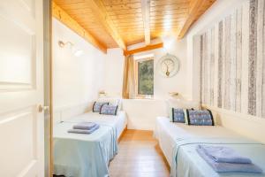 two beds in a room with a window at Panoramico in Oden +20 photos