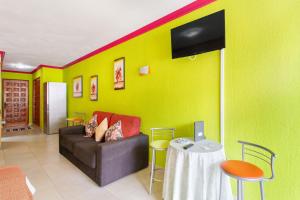 a living room with a couch and a tv on a wall at Arcoiris Al Mar Playa San Marcos in San Marcos