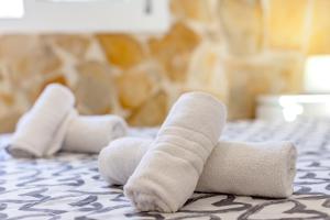 a pair of white knee socks on a bed at Cala en Forcat in Menorca +17 photos