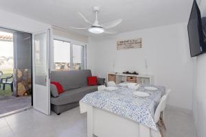 a living room with a table and a couch at Cala en Forcat in Menorca