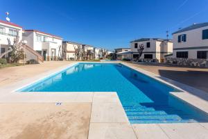 a blue swimming pool in the middle of a building at Cala en Forcat in Menorca