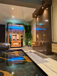 a lobby with a pool in the middle of a building at Lot54 Holiday Homes in Feuerscheid