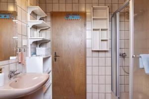 a bathroom with a sink and a shower at Heidi's Panoramablick in Neuerode +16 photos