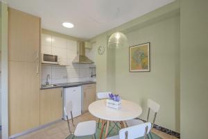 a kitchen with a table and chairs in a room at El Vall in Sant Llorenç de Morunys +14 photos