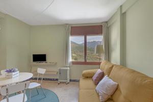 a living room with a couch and a table at El Vall in Sant Llorenç de Morunys