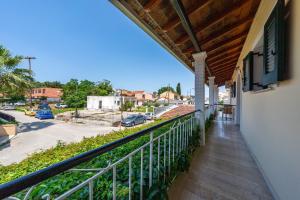 a balcony with a view of a street at Eli Guesthouse in Kavos