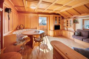a living room with a table and a couch at Ciasa Giorgina a Pozza di Fassa in Pozza di Fassa