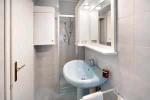 a white bathroom with a sink and a shower at Ciasa Giorgina a Pozza di Fassa in Pozza di Fassa +15 photos