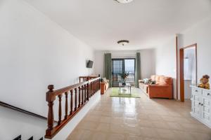 a living room with a staircase and a couch at Casa ino in Punta del Hidalgo