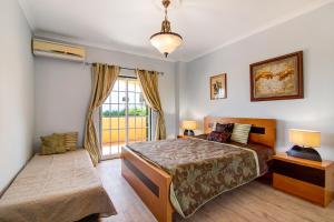 a bedroom with a bed and a window at Casa do Sobreiro in Quelfes +24 photos