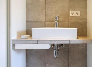 a bathroom with a white sink on a counter at Ferienwohnung Jung und Lind in Bretten