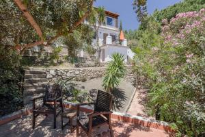 a patio with two chairs and a house at Apartment Luna in Salobreña
