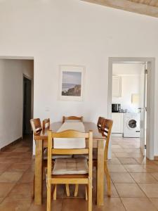 a kitchen and dining room with a table and chairs at Paraiso da Serva - Flor do Rosto 2 in Odemira