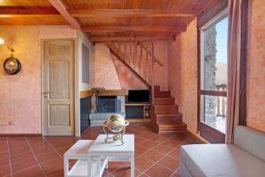 a living room with a couch and a fireplace at Cascina Taronico in Bellagio
