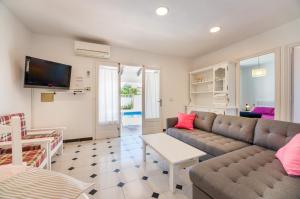 a living room with a couch and a table at Villas Vanessa & Ruth in Cala en Porter