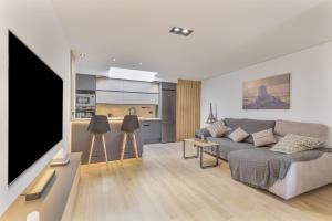 a living room with a couch and a flat screen tv at Casa con terraza cerca del mar in Telde