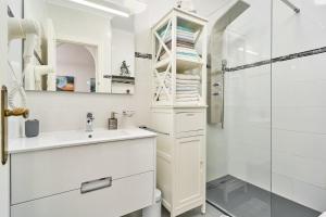 a white bathroom with a sink and a shower at Ferienwohnung Peñoncillo in Torrox +18 photos