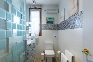 a bathroom with a toilet and a window at Estudio La Barquera in San Vicente de la Barquera +21 photos