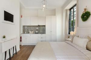 a white kitchen with a bed in a room at Vila Francisco in Funchal +80 photos