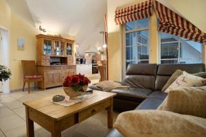 a living room with a couch and a coffee table at Wellness-Residenz Wohnung 19 in Zingst
